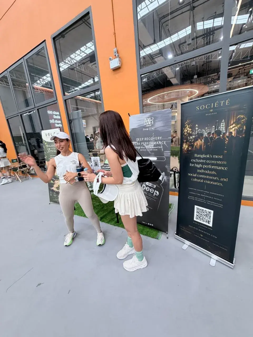 Guests talking beside the Société Bangkok display