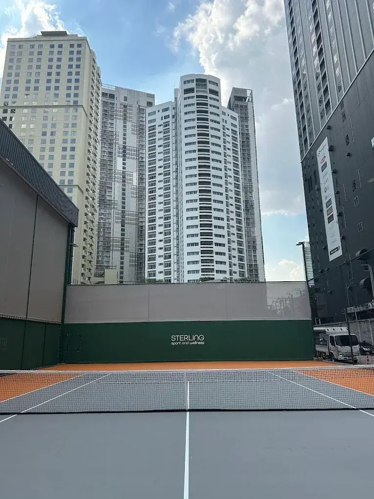 Sterling racquet court framed by Bangkok high-rise buildings