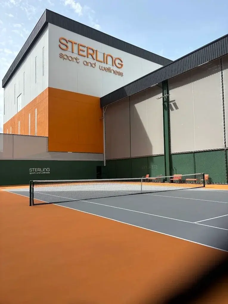 Sterling Sport and Wellness building beside an outdoor racquet court