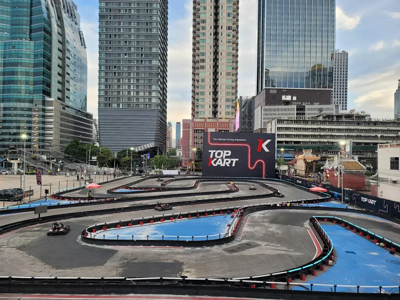 Top Kart Bangkok circuit with several karts among city buildings