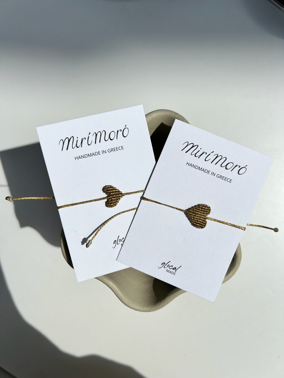 mirí moró gold heart bracelets on handmade cards